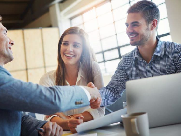 three people meeting and shaking hands