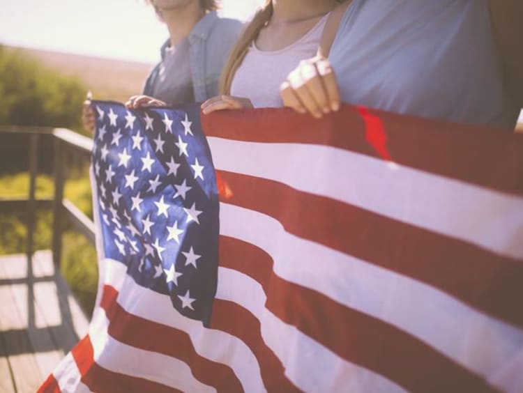 family holding american flag