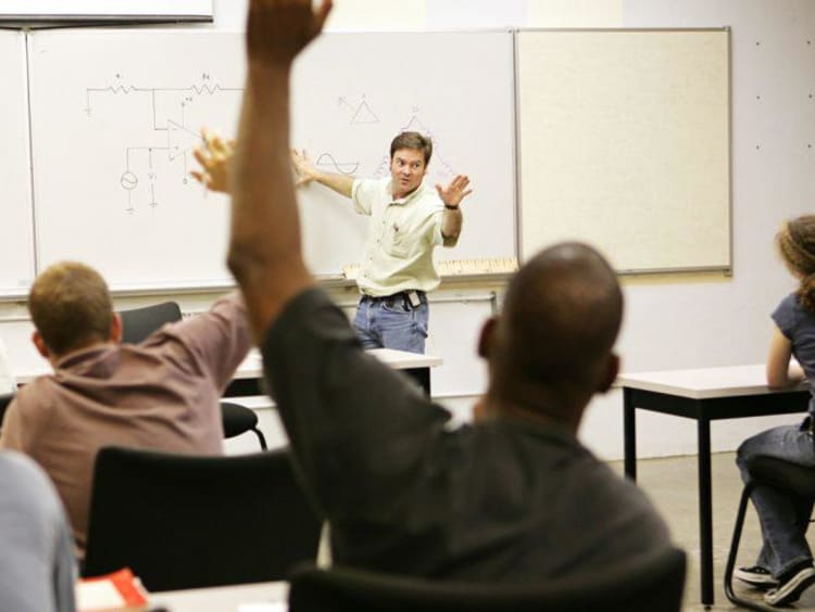 Man raising hand in class