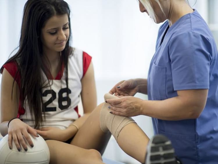 athletic trainer treating a patient