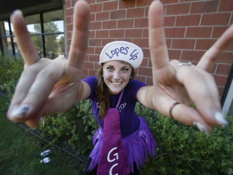 student wearing purple holding lopes up