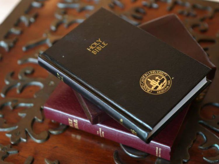 The Bible laying on an ornate tablecloth