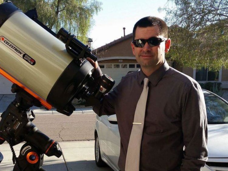 Brent Phillips at his home next to his large telescope