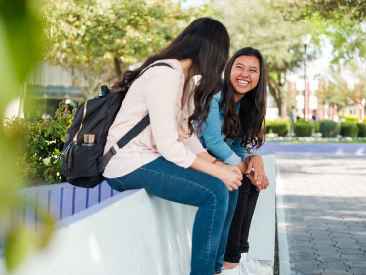 two girls talking with each other at school