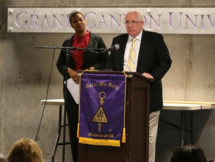 Leader speaks at a Delta Mu Delta orientation
