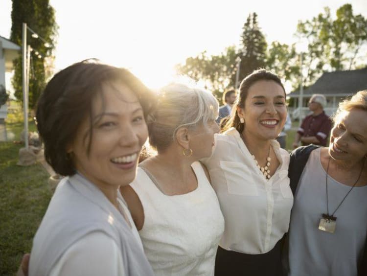 four women laughing together