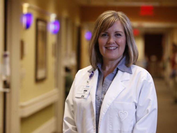 Female DNP wearing white coat in hospital