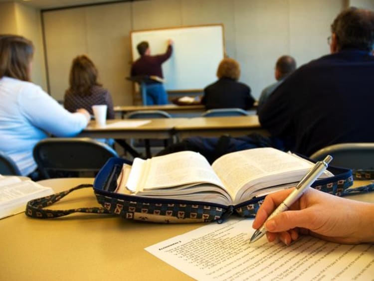 Students in the classroom writing an assignment