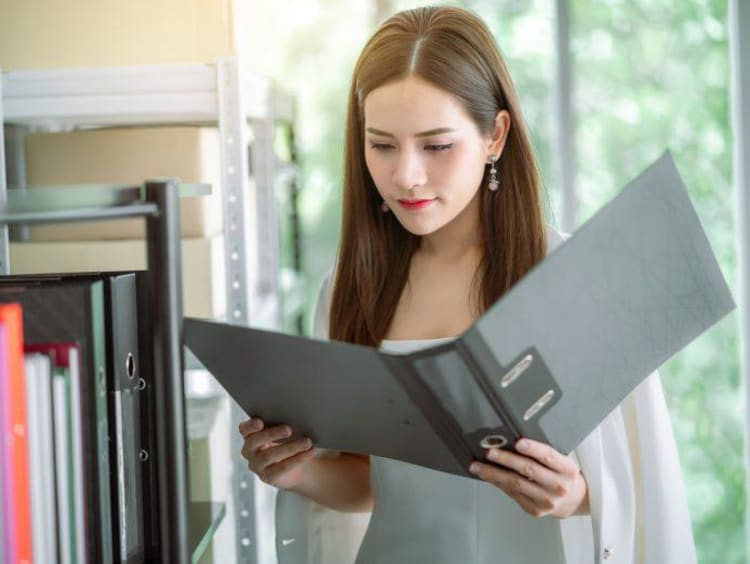 Woman looking through a binder