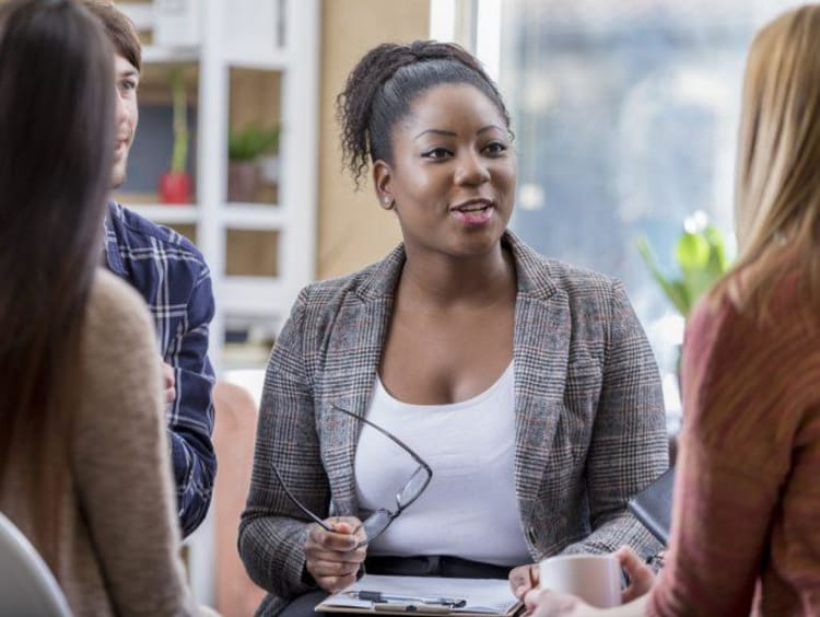 Behavioral health manager leads team discussion in small group