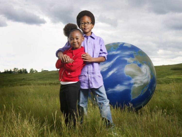 children with globe behind them