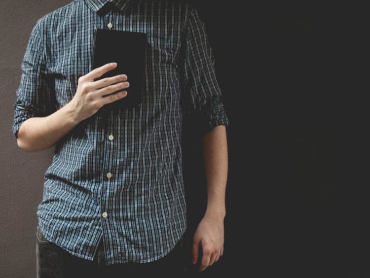 man holding a book on his chest