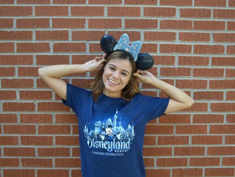 Student poses with Disneyland Resort shirt and Mickey Mouse ears on