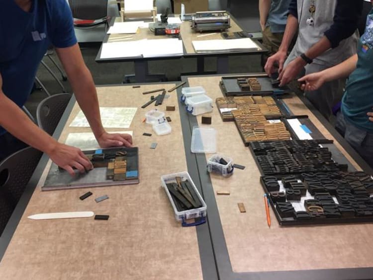 Students typesetting with wood type