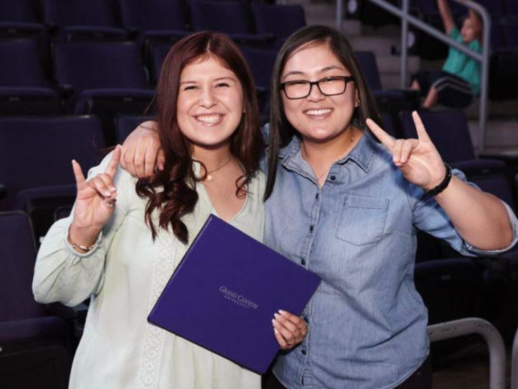 two students holding a lopes up