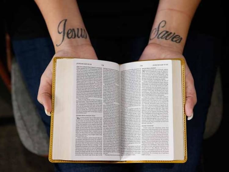 person holding open a bible