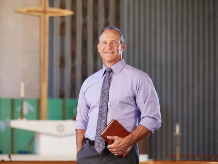 Adult man outside of the Theology building