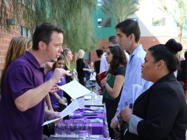 people talking at a job fair