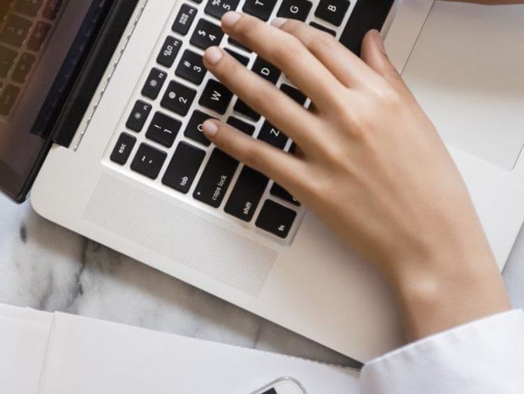 Woman typing on laptop