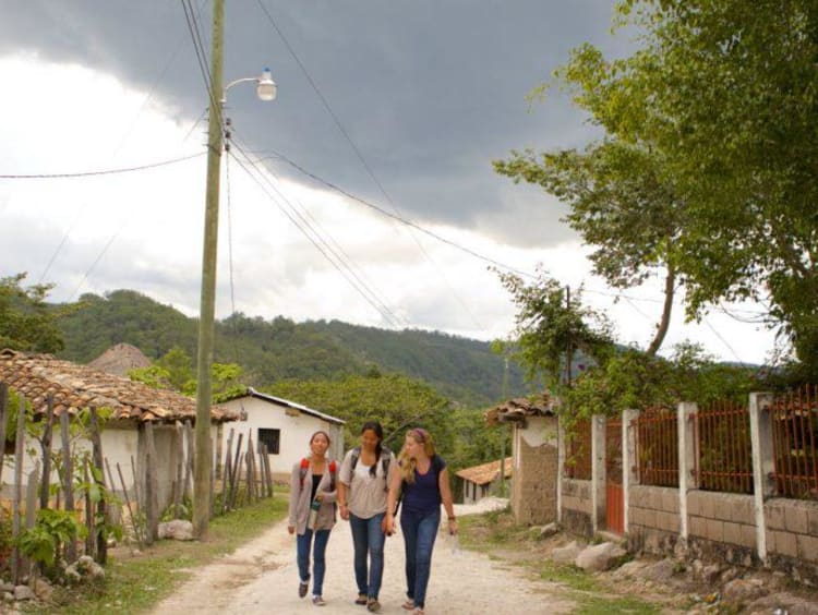 girls walking on dirt path