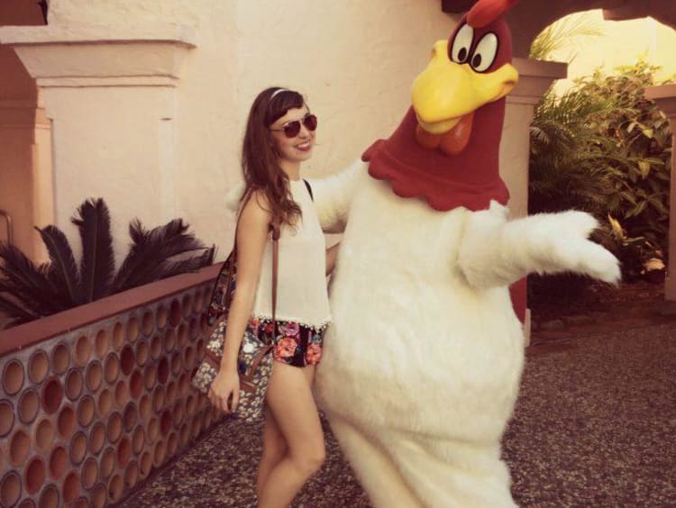 Kaitlyn stands with Foghorn Leghorn in Gold Coast