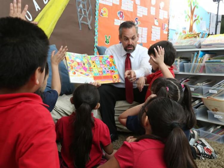 students raising their hand ready to answer a question