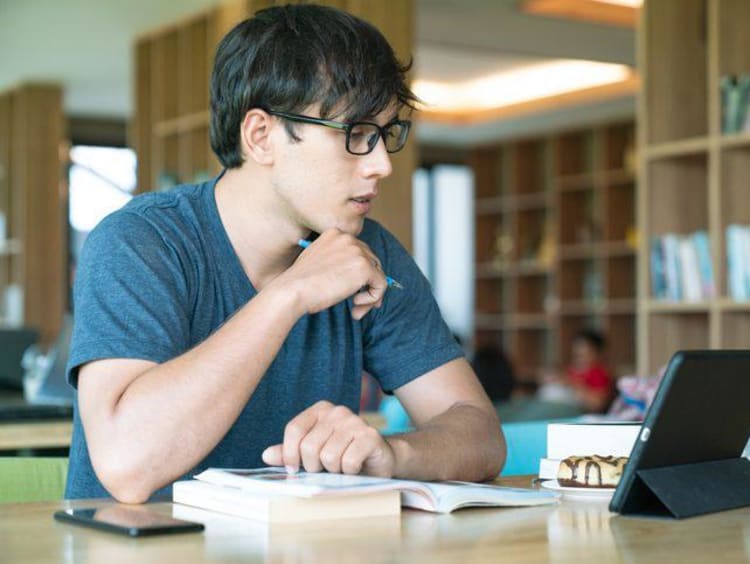 Male student working on laptop