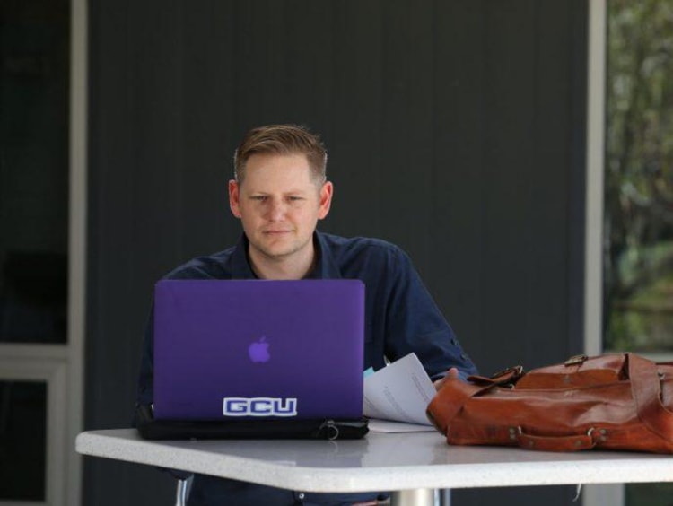 Doctoral learner working on a laptop