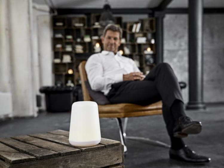 Man sitting beside a digital assistant