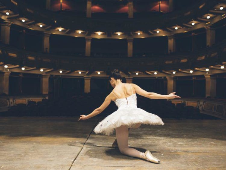 Ballerina taking a knee after a performance