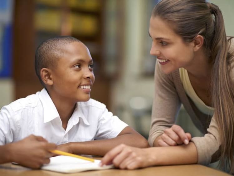 teacher helping student