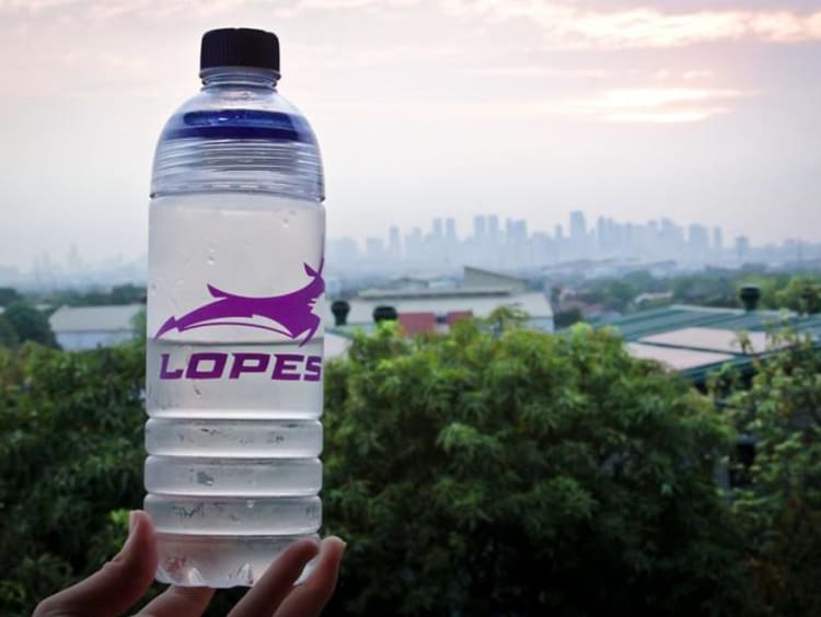 Lopes water bottle shows Philippines landscape in background