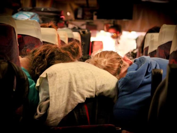 people asleep on a bus