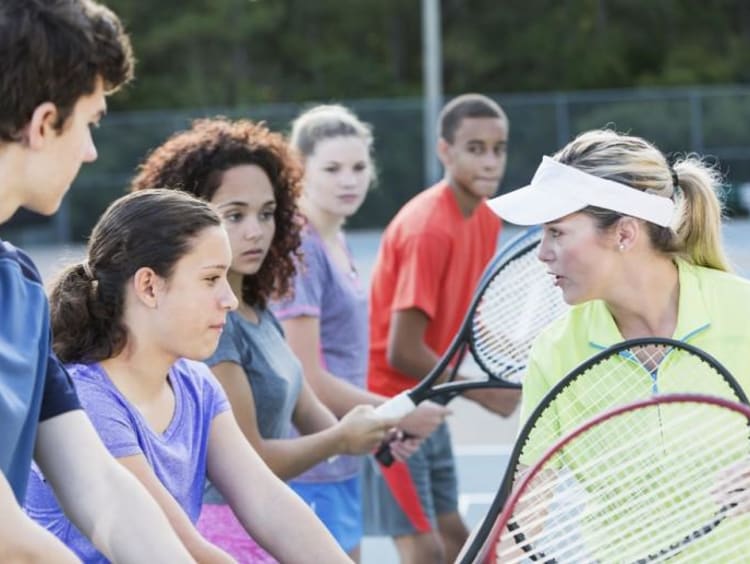 kids learning to play tennis