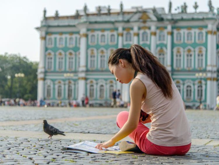 Young female tourist studying map