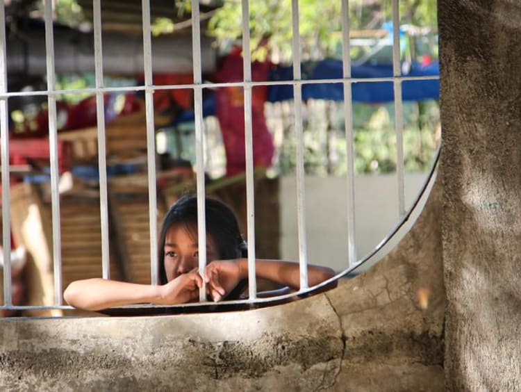 A girl looking through a window