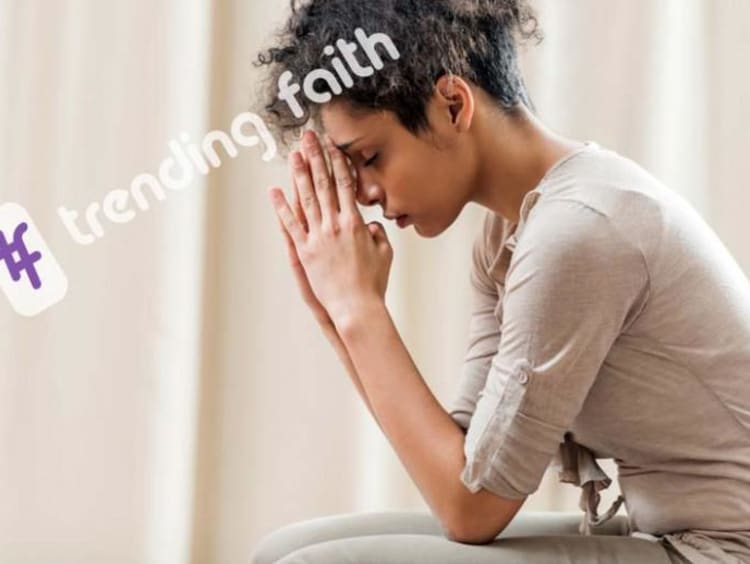 A person praying with the Trending Faith logo