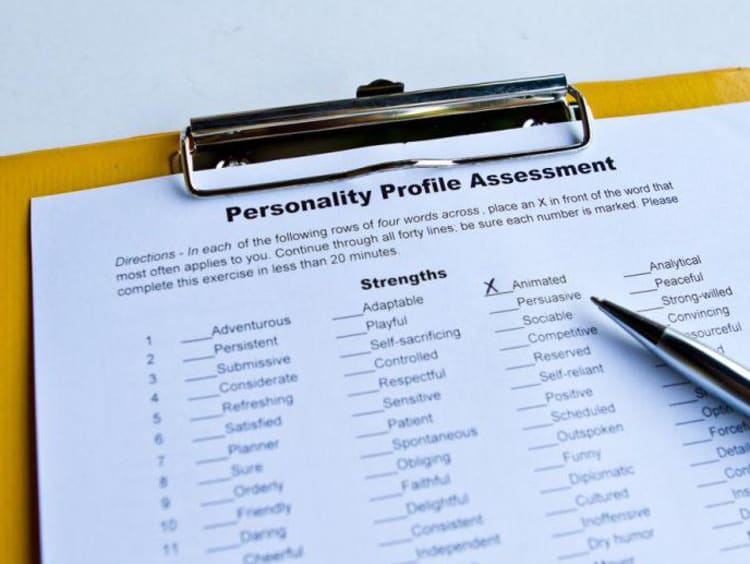 Personality profile assessment on a clipboard with an x next to one characteristic