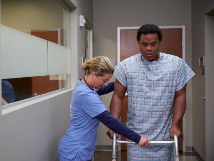 a registered nurse helping her patient