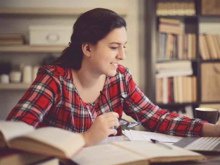 female Master of Divinity online degree student learning from home