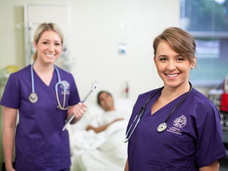 two GCU nurses with a patient