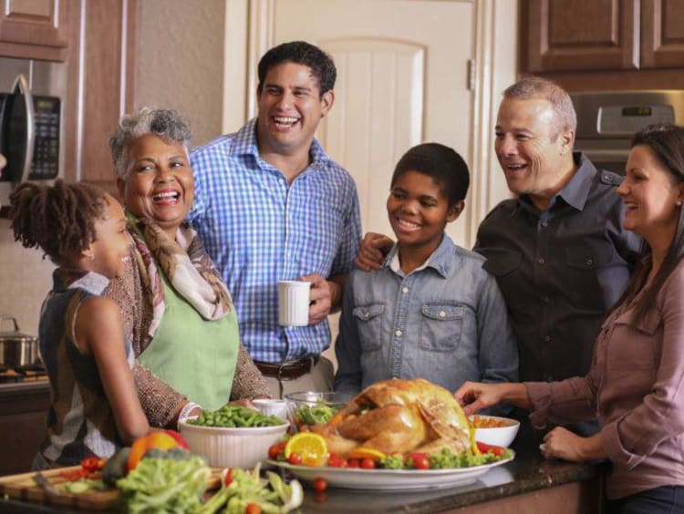 family smiling and laughing in the kitchen