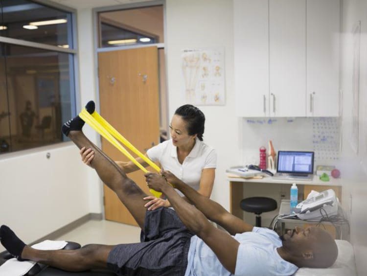 athletic trainer helping client