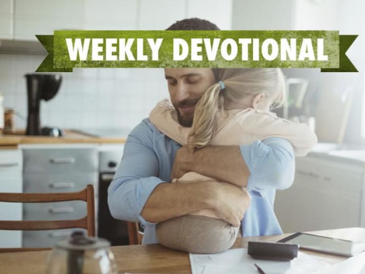 A parent hugging his child under the Weekly Devotional banner