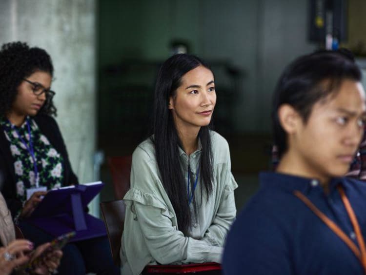 Attentive woman in an audience at a presentation