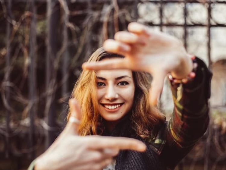 person holding hands out framing something