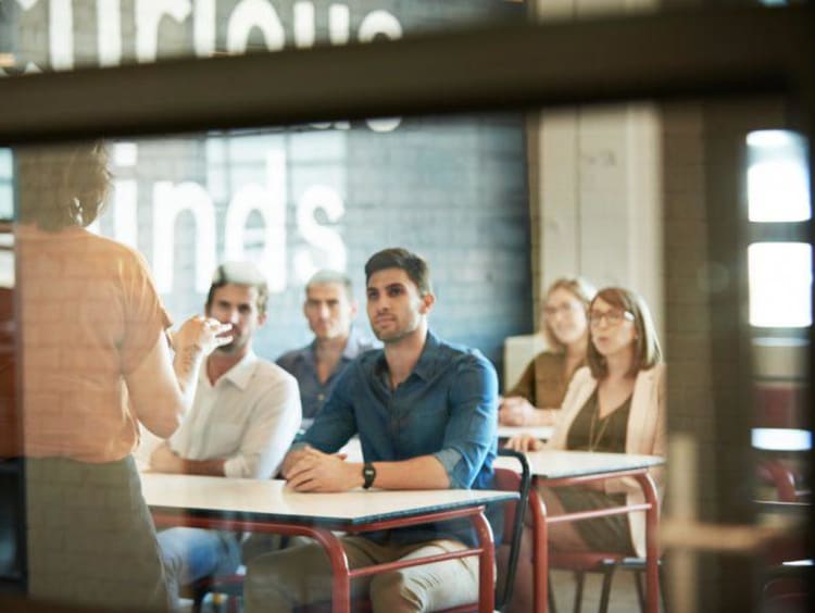 Professor teaching adults in airy classroom