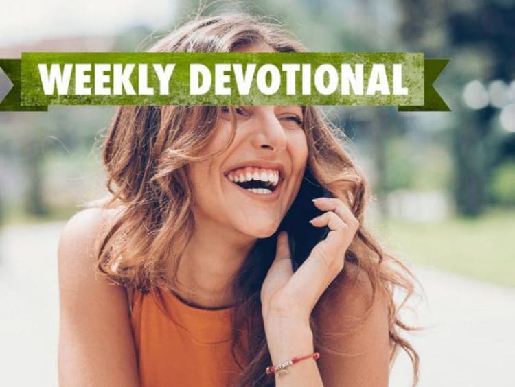 Weekly Devotional: Woman a cellphone smiling