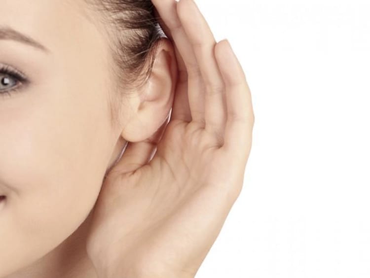 a girl cupping her ear