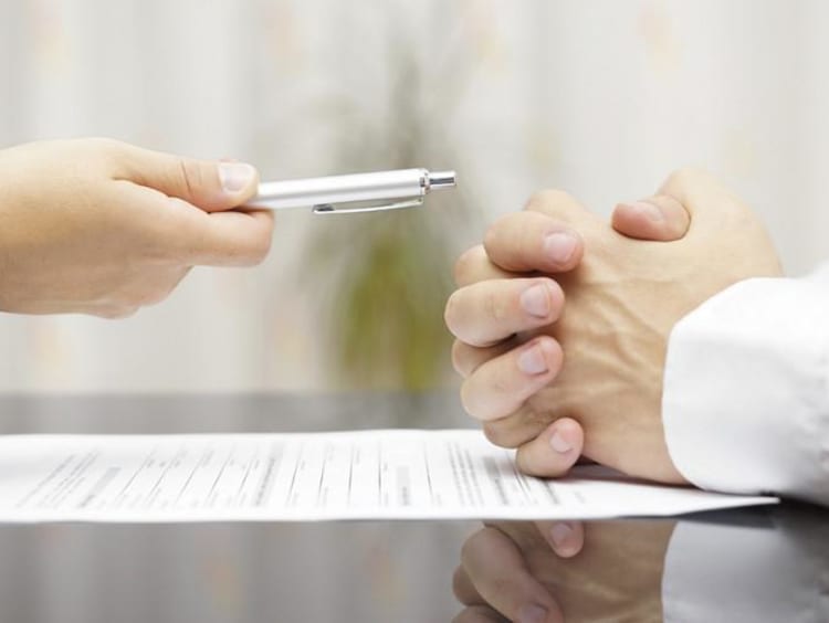 businessman offering a pen